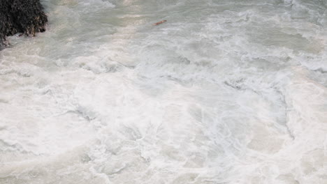 close up of rapids flowing between rocks in 4k