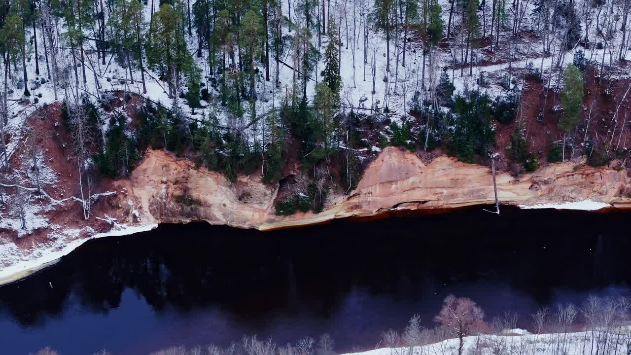 Cinematic drone view of sandstone Velnala cliffs and Devil’s Cave in Latvia