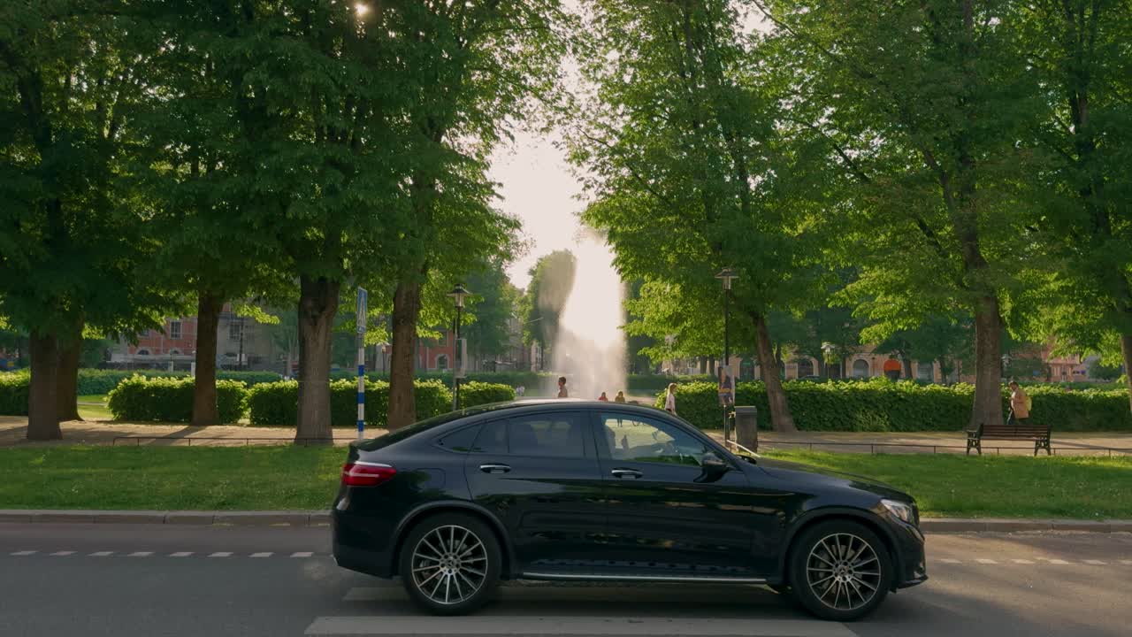 Sunny morning view of Karlaplan city square with fountain and greenery in Stockholm, Sweden