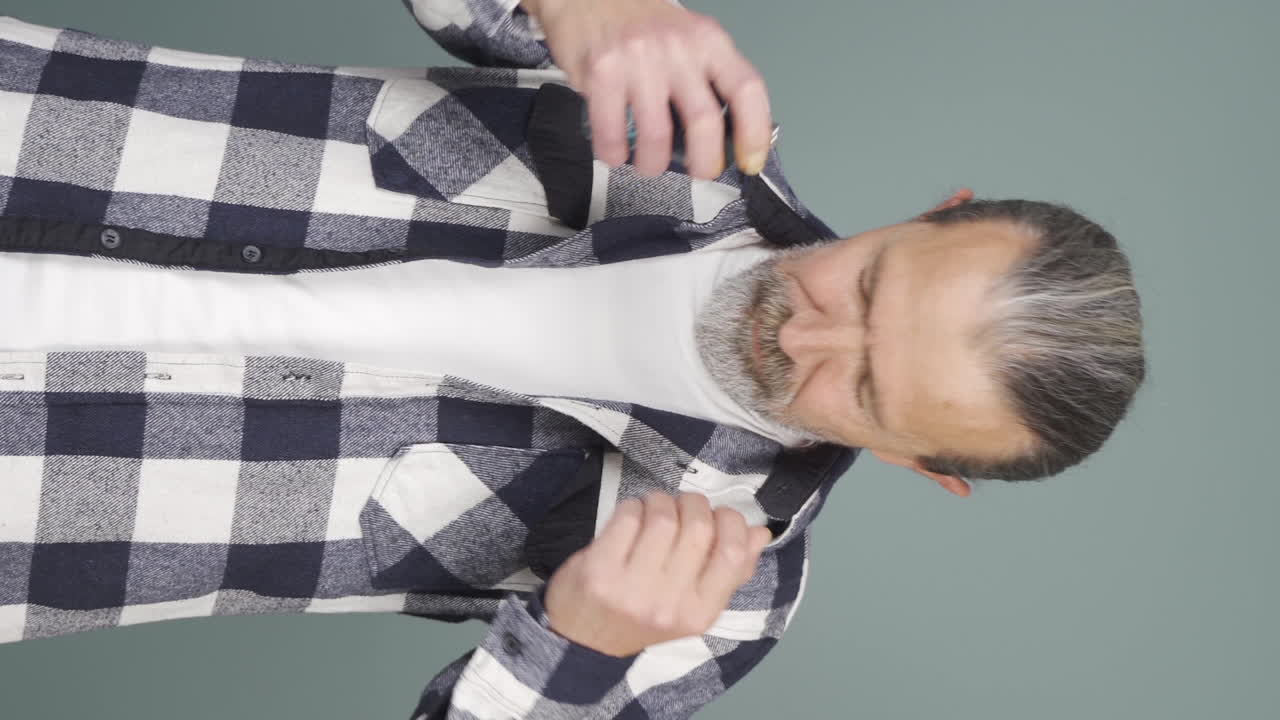 Vertical video of The old man who puts on perfume and smells good.