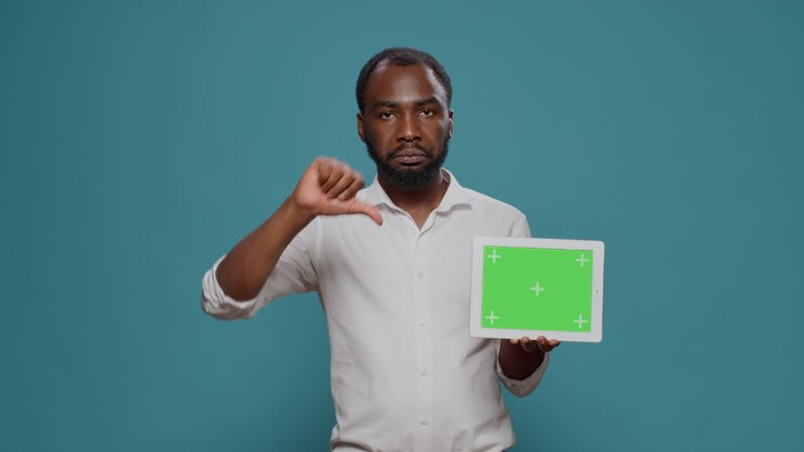 Man holding tablet with green screen