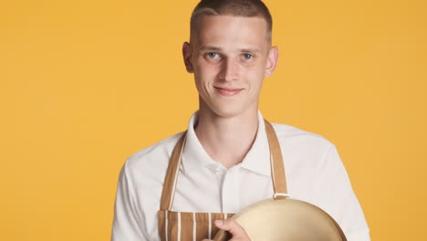 smiling guy in waiter uniform smiling