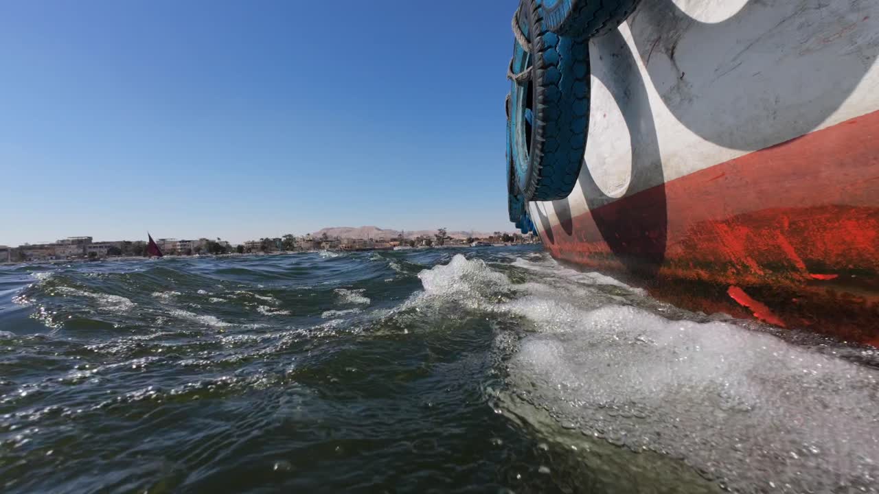 Tourist boat crossing Nile river in Luxor City on the way to Valley of Kings