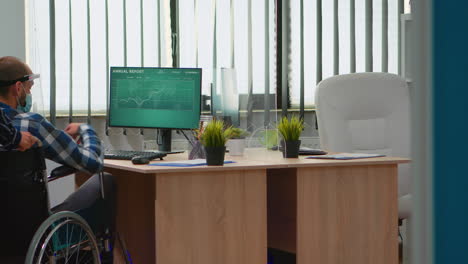 lady with face mask bringing immobilized man at workplace