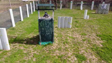 paintball player fires at the opponents and hides in a tower