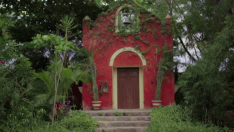 Red building with vegetation
