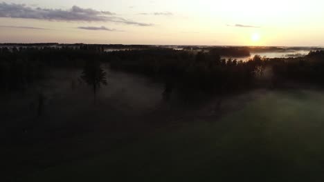 flight above sunset fog in golden hour after rain
