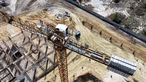 Drone-shot-from-a-construction-site,-descending-and-tilting-up