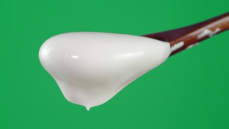 with a wooden spoon falls sour cream.