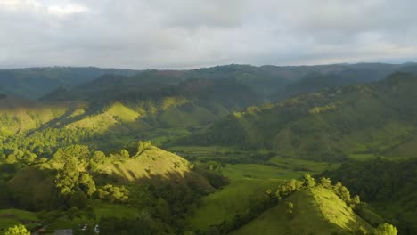 drone flies above cocora valley in salento, colombia during sunrise, truck left