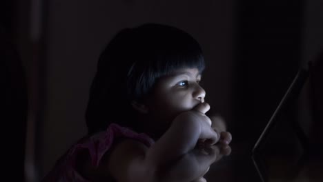 niño que usa una tableta por la noche