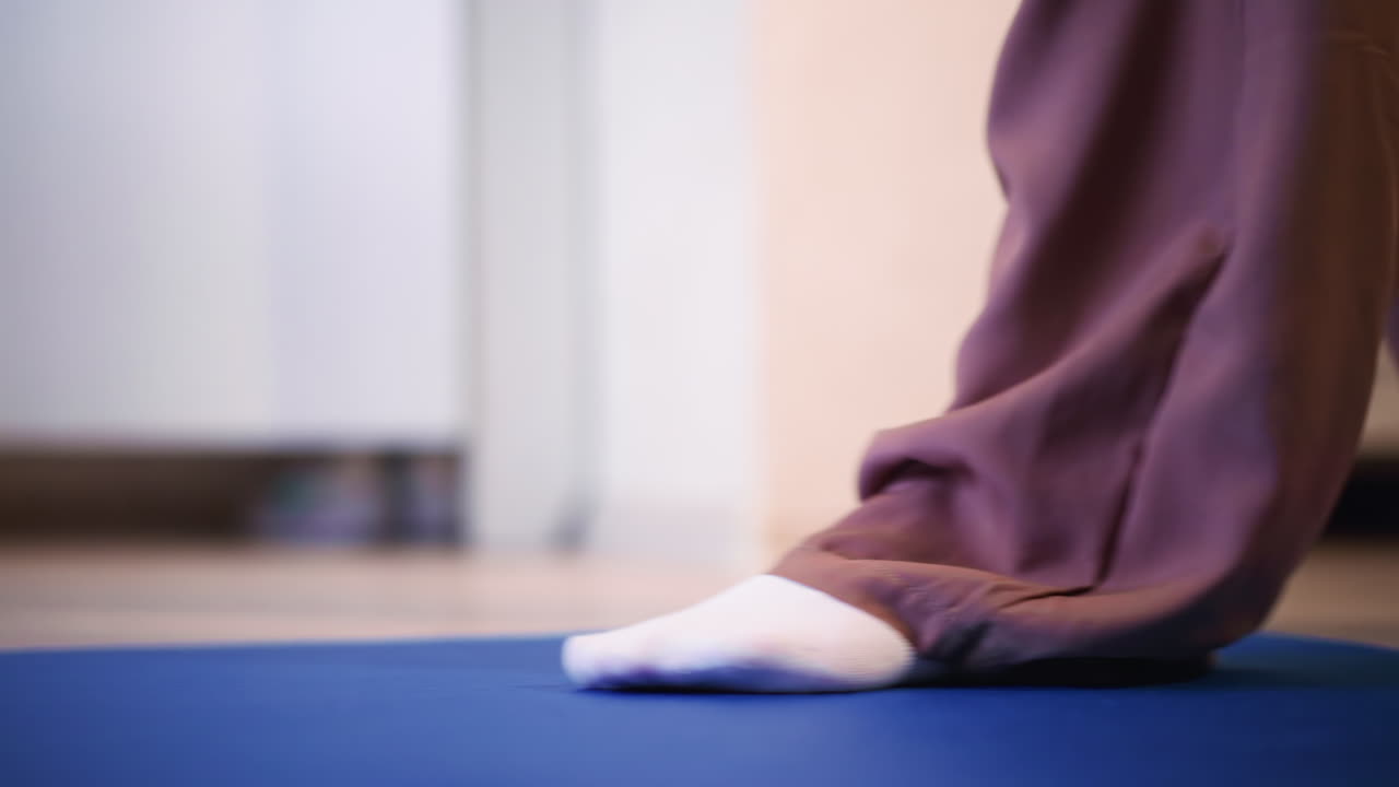 Slow Grounding Foot Movement On Blue Mat With Soft Kneel And Sock Contact Centering Exercise In Quiet Home Studio, Subtle Light, Calm Balance And Mindful Breath For Inner Stability