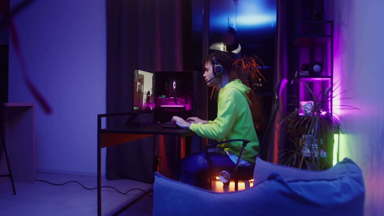 Teen gamer playing video game on computer