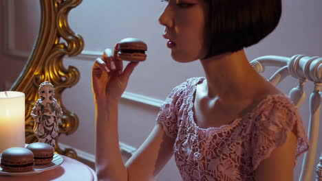 woman eating a macaron in a romantic bedroom setting