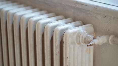 close up of a white radiator against a wall