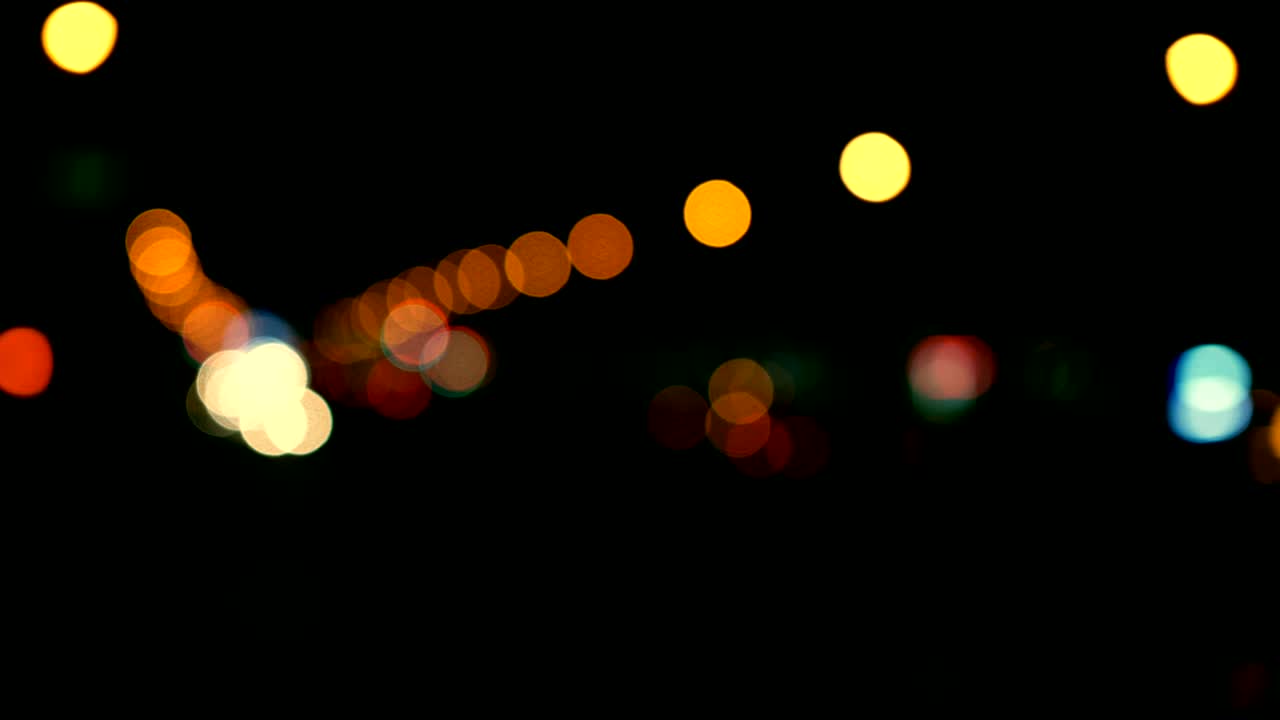 Defocused lights Los Angeles street abstract . City blur background. Moving bokeh circles of night traffic.