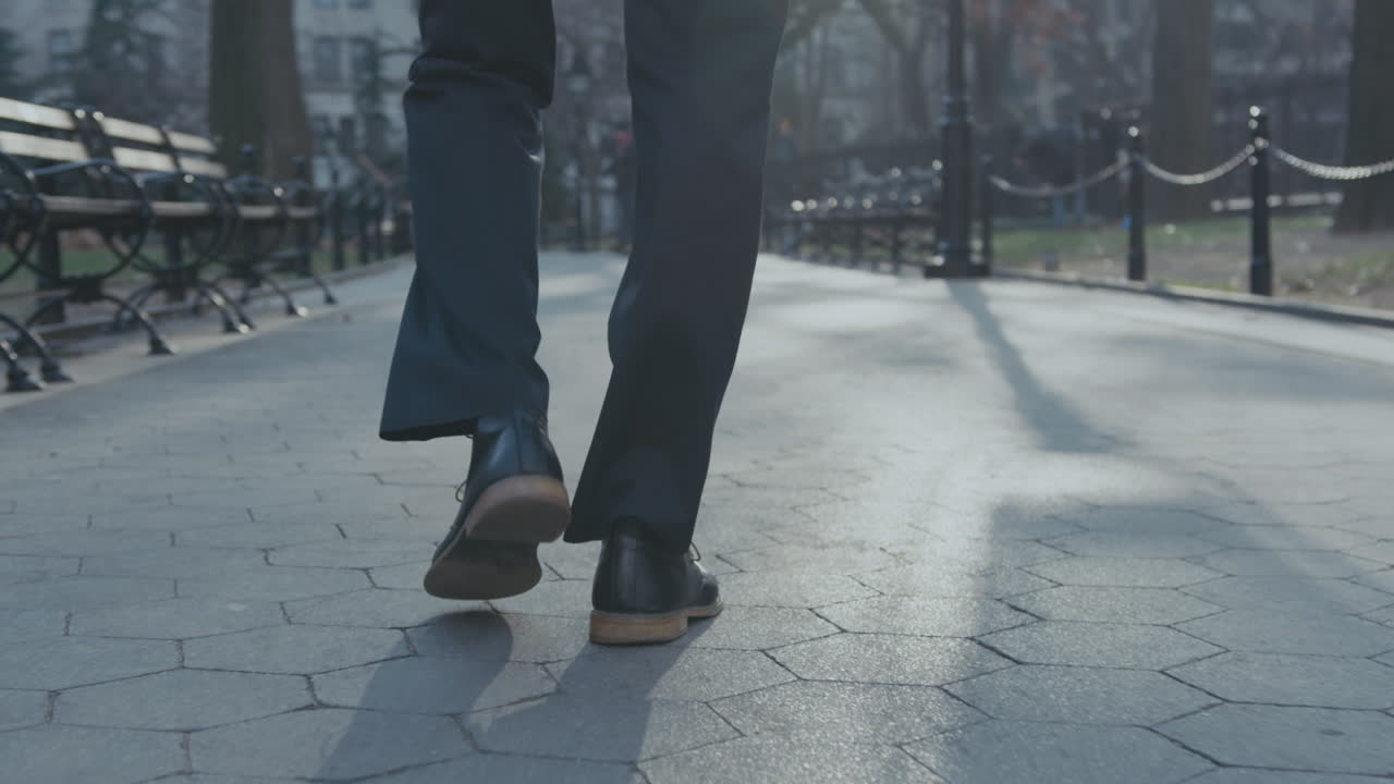 A person walks slowly in the park