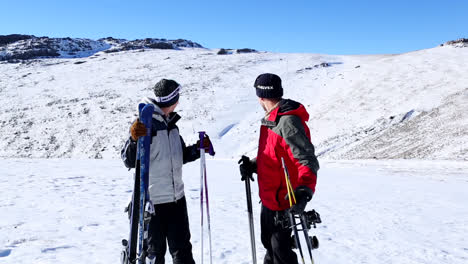 active couple holding skis and poles