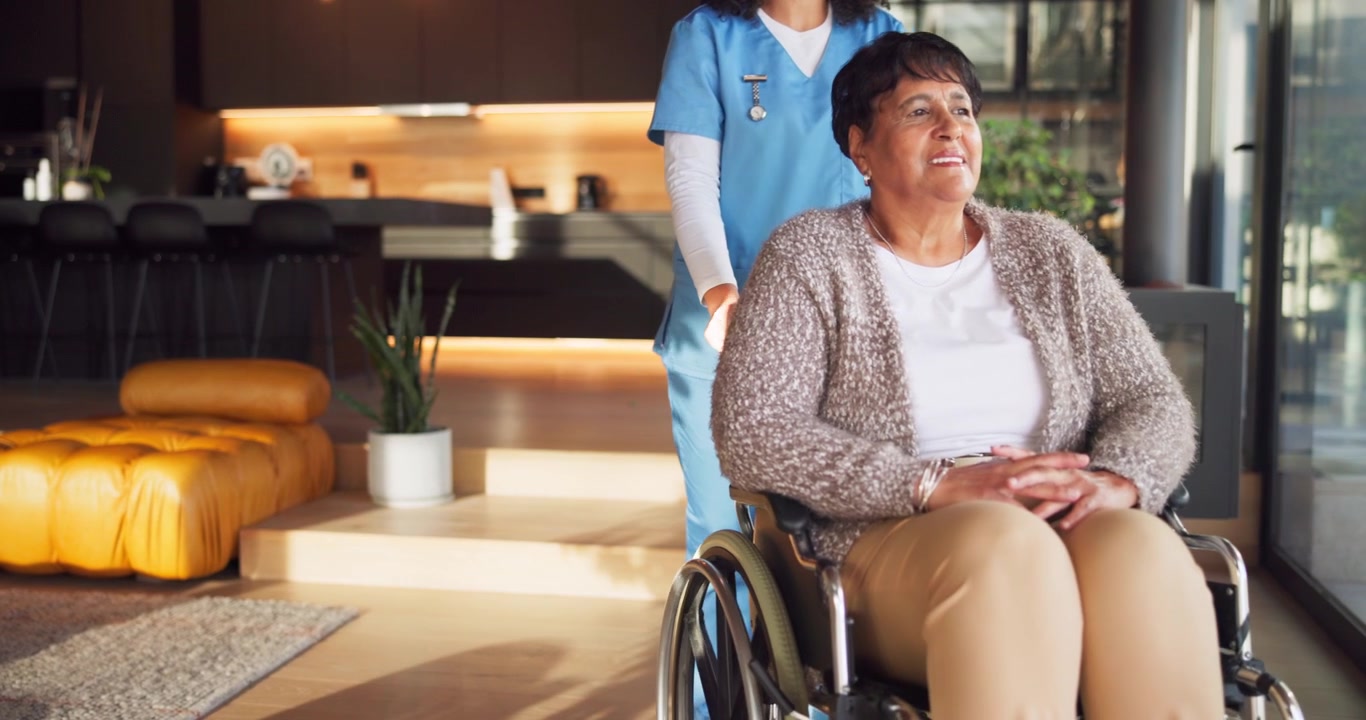 Caregiver Pushing Senior Woman in Wheelchair at Home