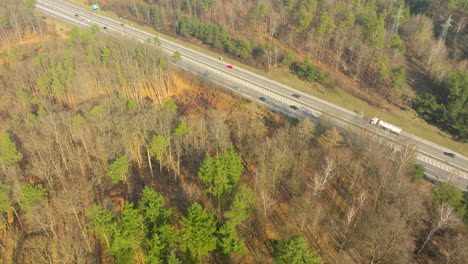 Driving-cars-on-highway-in-forest-landscape-of-Poland