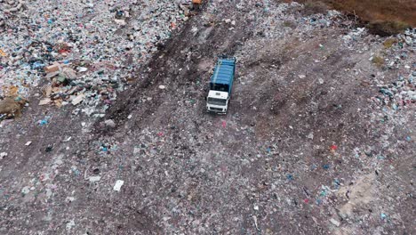 aerial view of landfill with waste management vehicles