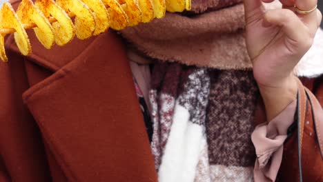 closeup of a person holding a spiral potato snack