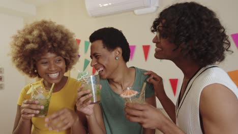Group of friends enjoying a party with cocktails
