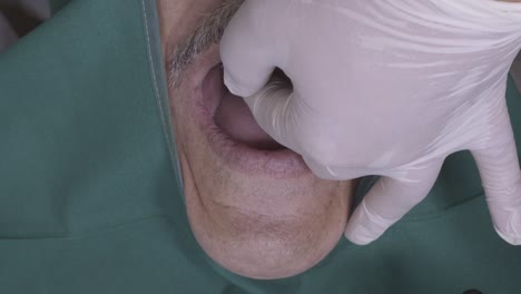 close-up view of a dentist examining a patient's mouth