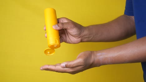 man applying lotion to hand