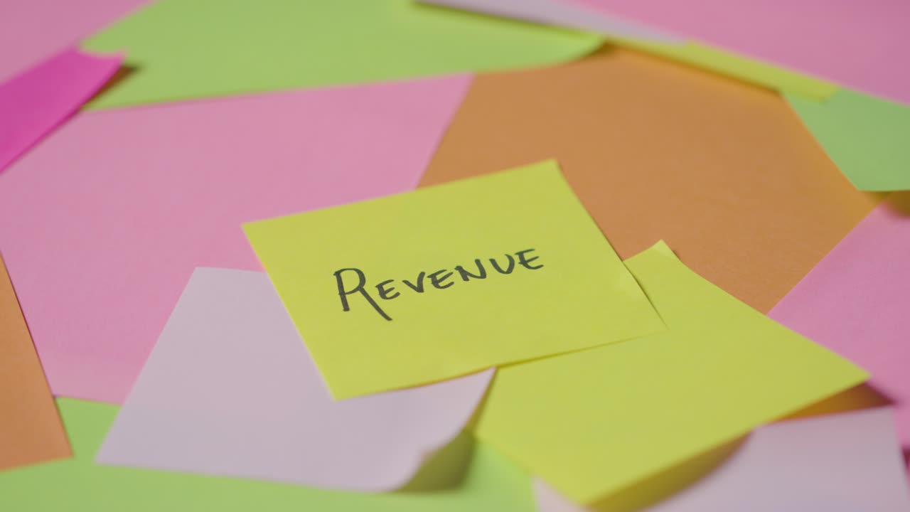 Business Concept Of Revolving Sticky Notes With Revenue Written On Top Note 2
