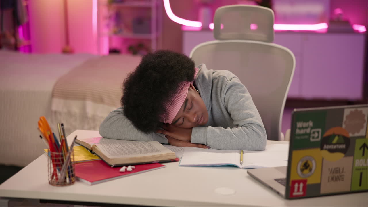 Young Black Woman Student Sleeping At Desk After Studying