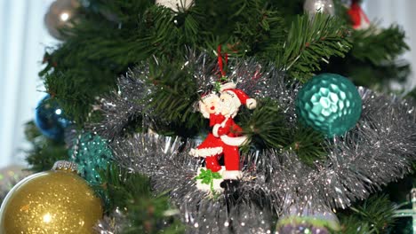 Panning-view-of-decorations---ornaments-on-a-Christmas-tree-in-a-home