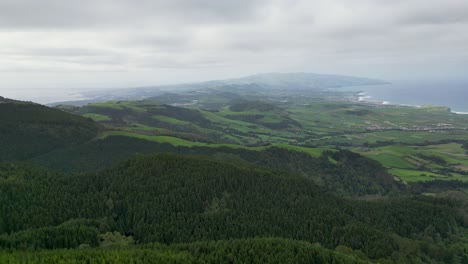 aerial view over verdant mountains and ocean in açores, portugal