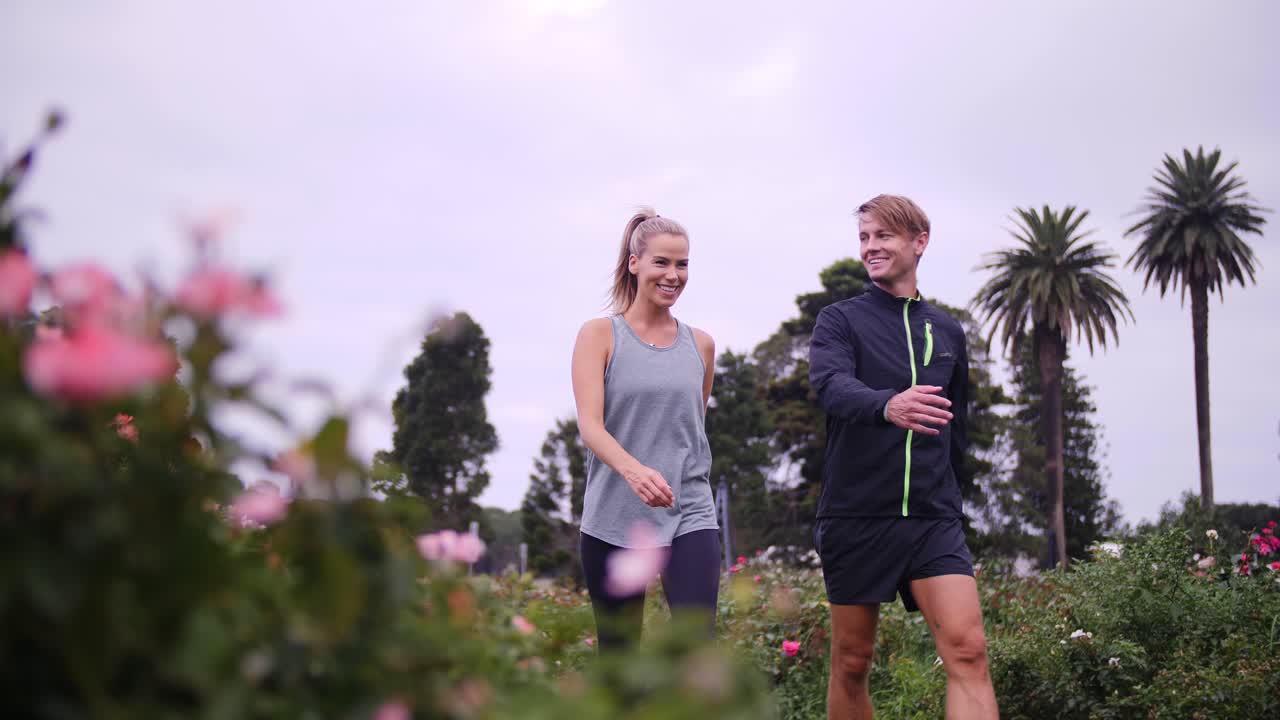 Couple Walks Through Rose Gardens On A Cloud Day