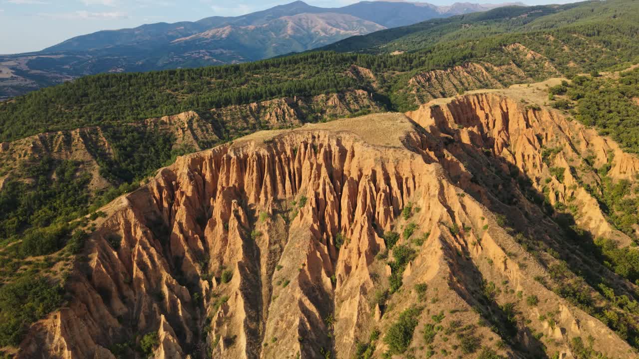 Aerial footage of sandstone towers at the Stob Earth Pyramids Bulgaria unique natural wonder with countryside scenery