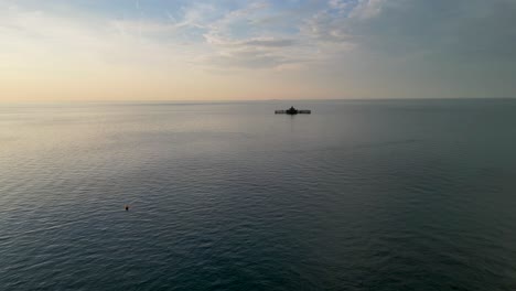Calm sea with a ruined pier on the horizon