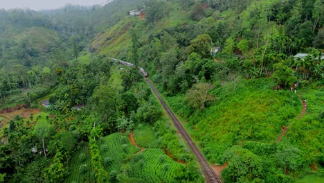 breathtaking aerial drone footage of a train crossing the iconic nine arches bridge in ella, sri lanka.