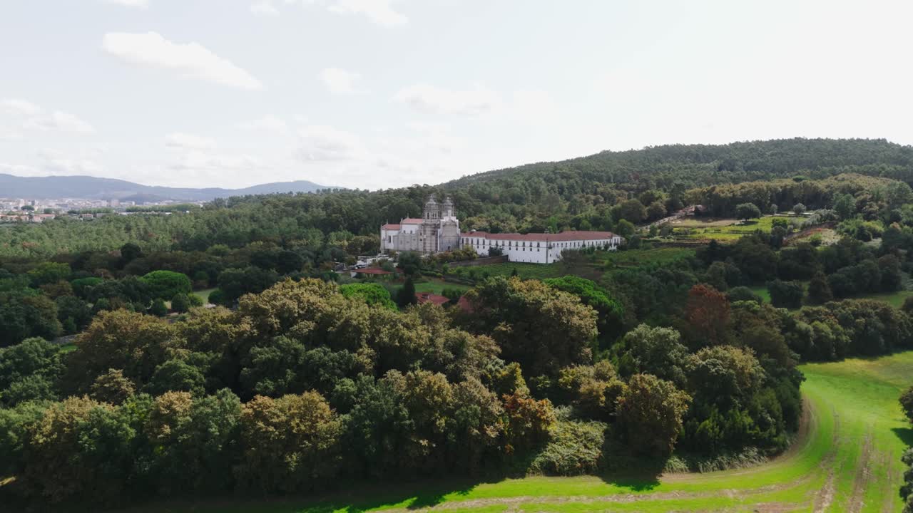 Drone view of Tibães Monastery framed by forest and open fields