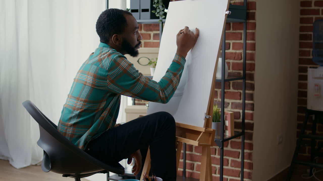 Young artist drawing vase masterpiece with pencil on canvas