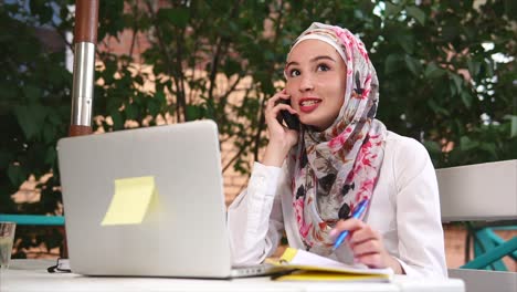woman working on laptop in cafe