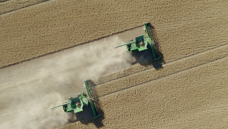 tractor machine harvesting at the vast farmland in saskatchewan, canada