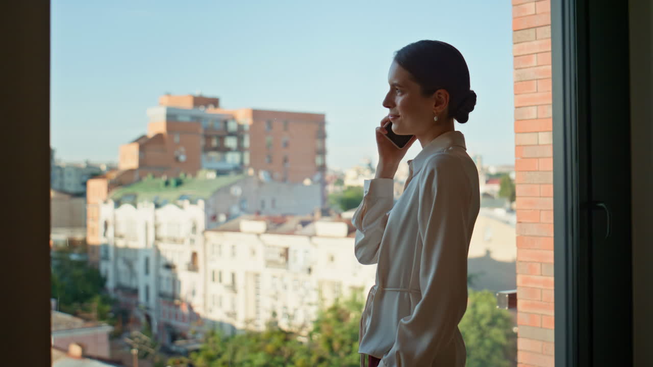 Confident lady boss calling mobile phone at office window closeup. Elegant woman