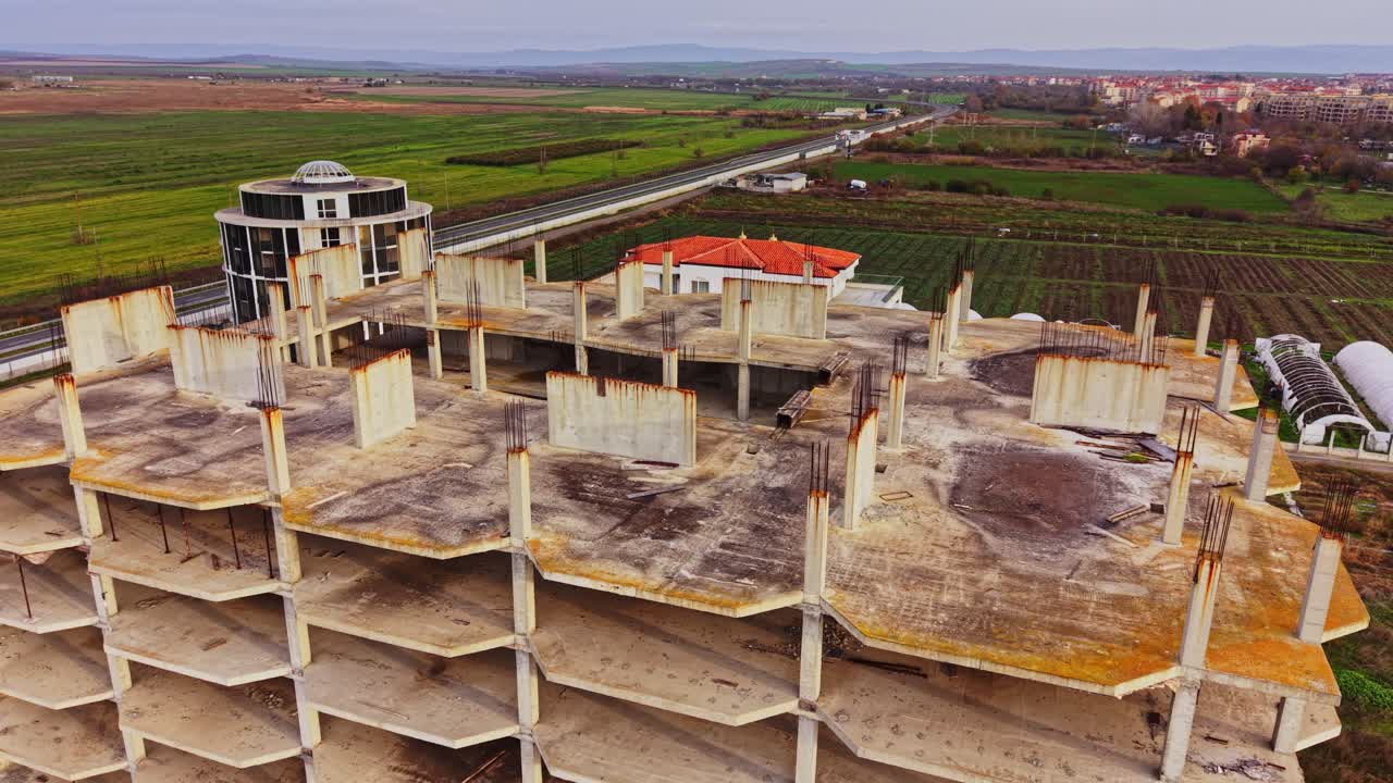 Aerial view of abandoned building in rural area with surrounding fields