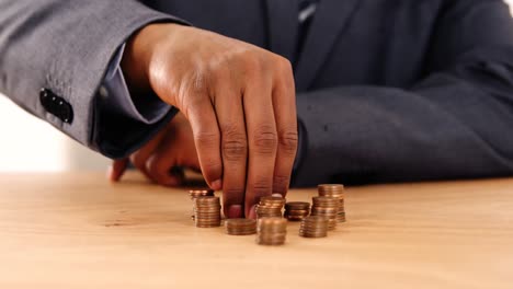 businessman with stacks of coins