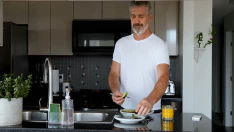 Man-preparing-breakfast-in-kitchen-4k