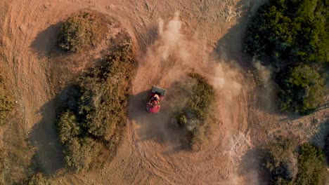 a single four wheeler dune buggy racing in circles on a dirt path at cavo greko