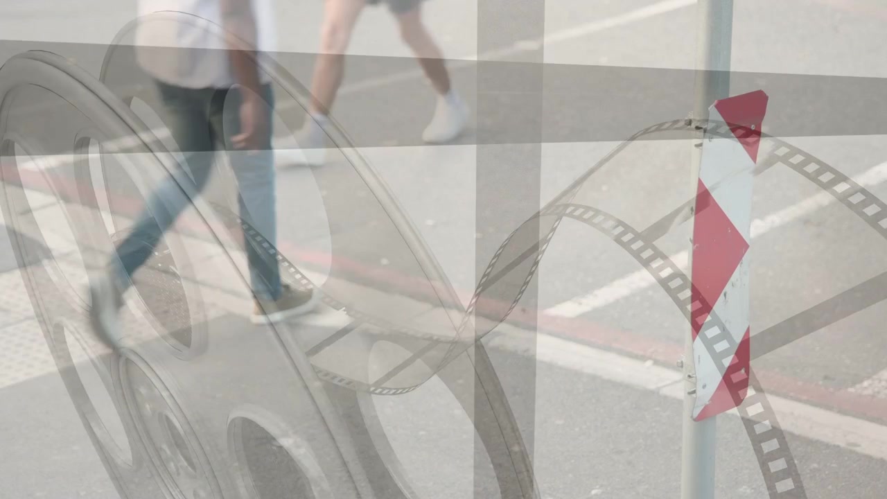 Adult male carrying child entering right, crossing crosswalk toward left while film-reel overlaying