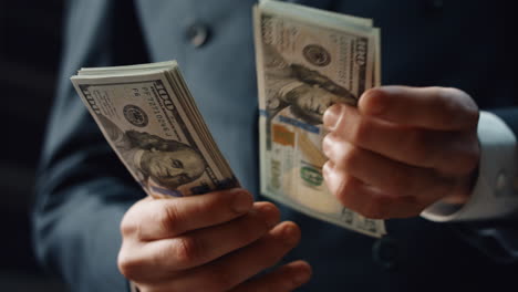 hands calculating dollar banknotes denomination of hundred indoors close up.