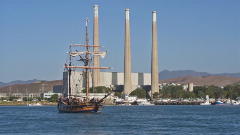 un barco alto navega más allá de la central eléctrica de morro bay, california
