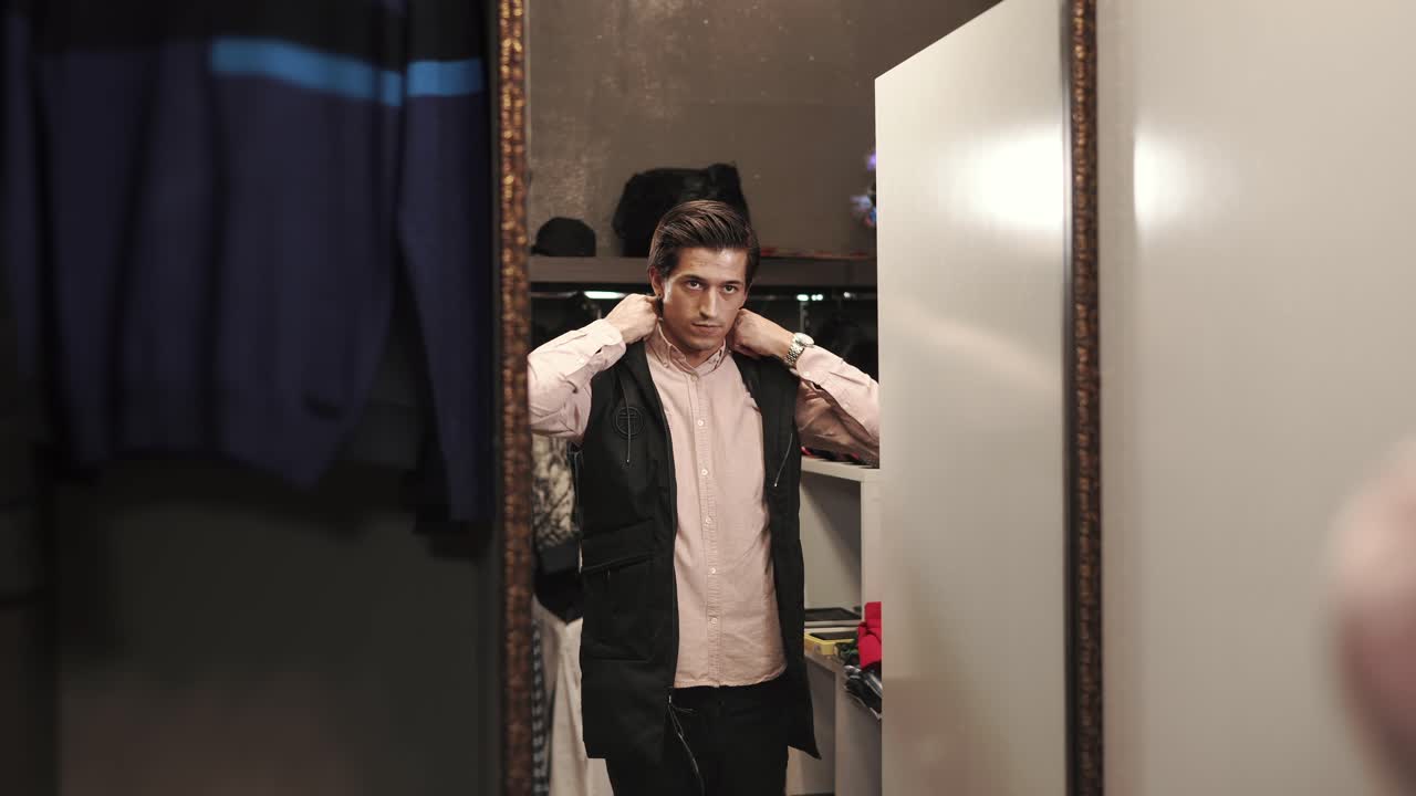 Man Trying On Clothes in a Dressing Room